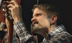 Kuinka nopeasti kitarankieli vaihtuu kesken keikan? Friggin kitaristi Tuomas Logrén näyttää mallia/YLE