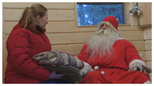 Annamari Eskola luovuttaa paketin pukille (copyright YLE/videokuvaa)