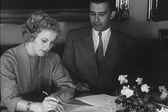 Kuva: Armi Kuusela kirjoittaa elokuvasopimusta. Vierell� tuottaja Veikko Itkonen. YLE kuvanauha. 