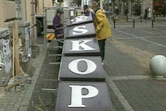 Kuva: SKOPin kyltti� poistetaan Aleksanterinkadulla. YLE kuvanauha.