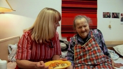 Kuva: Omahoitaja Sirpa avustaa Hiljaa ruokailussa. Yle kuvanauha (2011).